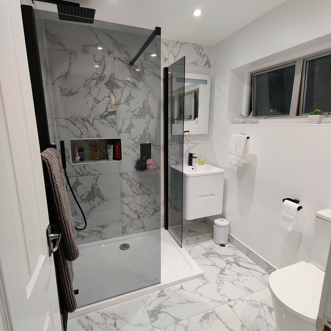 A luxurious, fully renovated bathroom with marble tiles