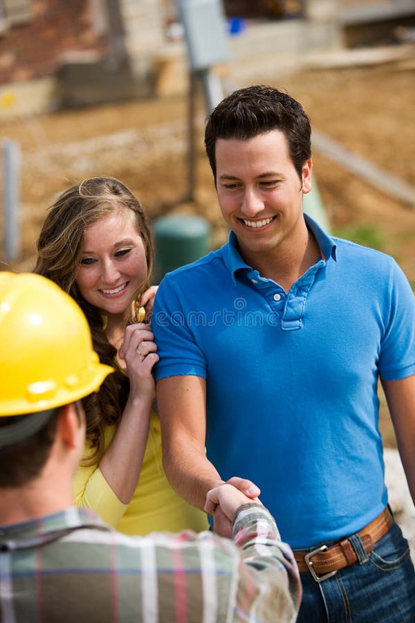 Homeowner meeting with a contractor on a construction site