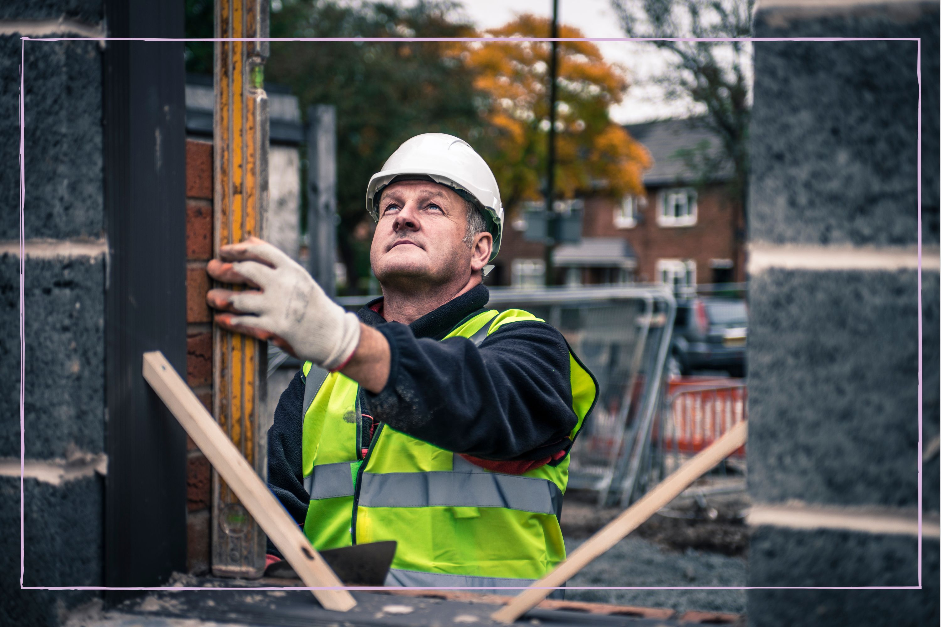 Professional UK builder working on a brick wall